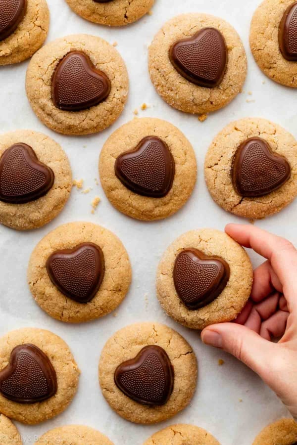 hand holding a peanut butter Valentine's Day cookie.